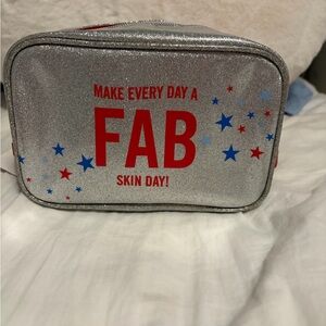 First Aid Beauty Silver and Red Bag